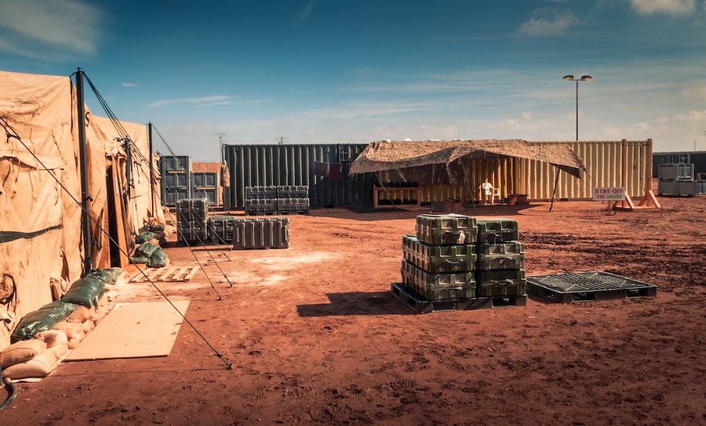 shipping crates and supplies in desert area